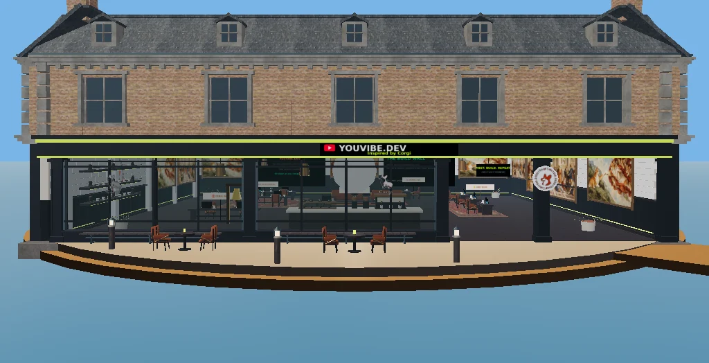 The actual YouVibe.dev Café façade: charcoal storefront, lime trim and Inspired by Corgi on the sign.
